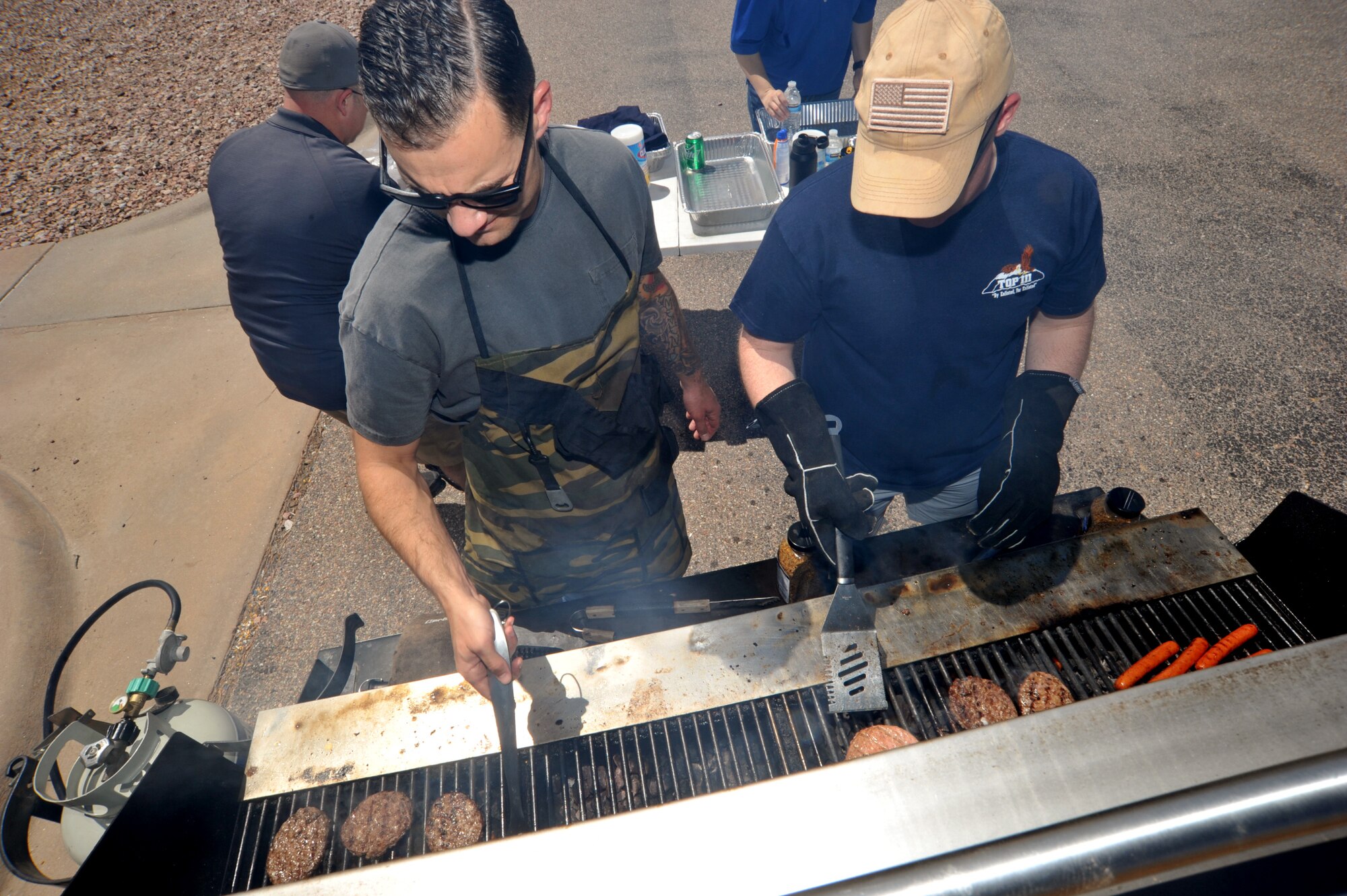 Men cooking burgers