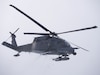 An Alaska Air National Guard 210th Rescue Squadron HH-60G Pave Hawk transits Joint Base Elmendorf-Richardson's Malamute Drop Zone Feb. 10, 2021, during parachute jump operations. The jump presaged the change-of-command ceremony for 212th Rescue Squadron. (U.S. Air National Guard photo by David Bedard)