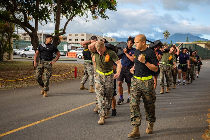 U.S. Marines with Staff Noncommissioned Officers Academy Hawaii lead poolees with Recruiting Substation Honolulu on a run during a poolee function on Marine Corps Base Hawaii, June 3, 2022. SNCOA-Hawaii personnel conducted the training alongside Recruiting Substation Honolulu to promote community relations and increase recruit resiliency. (U.S. Marine Corps photo by Cpl. Israel Ballaro)
