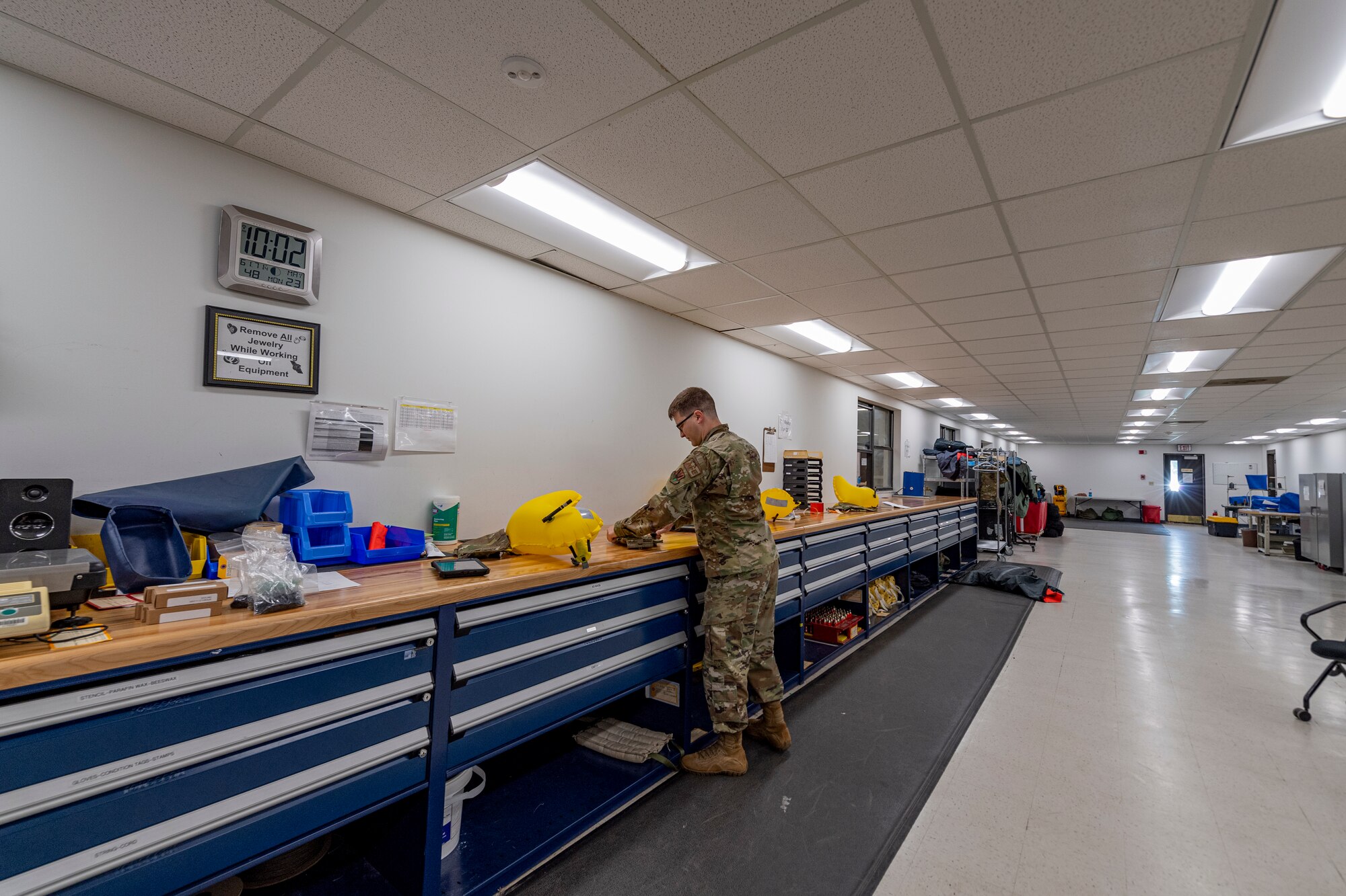 Photo of an Airman performing maintenance on a combat tactical aid flotation