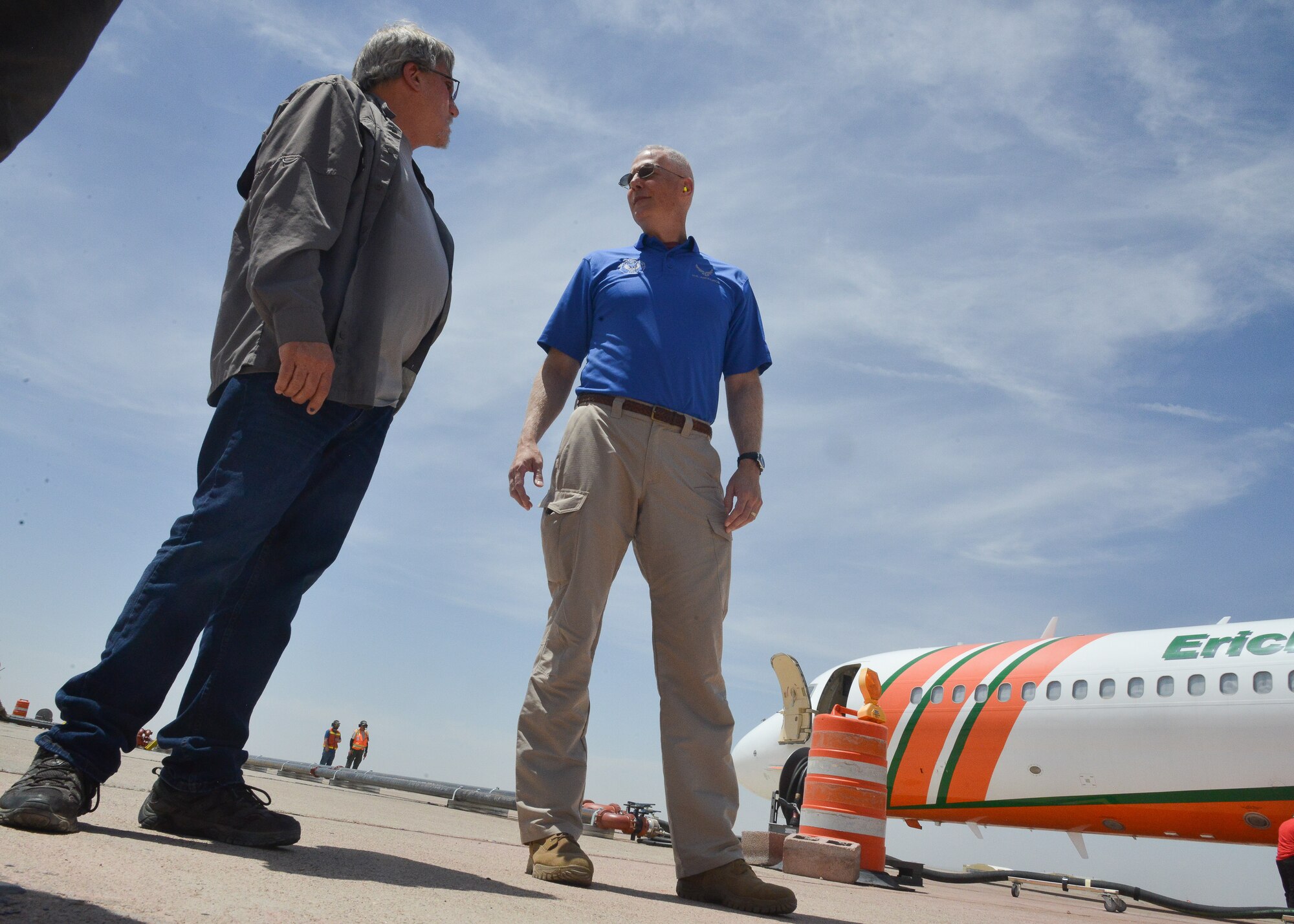 Men standing on flight line.