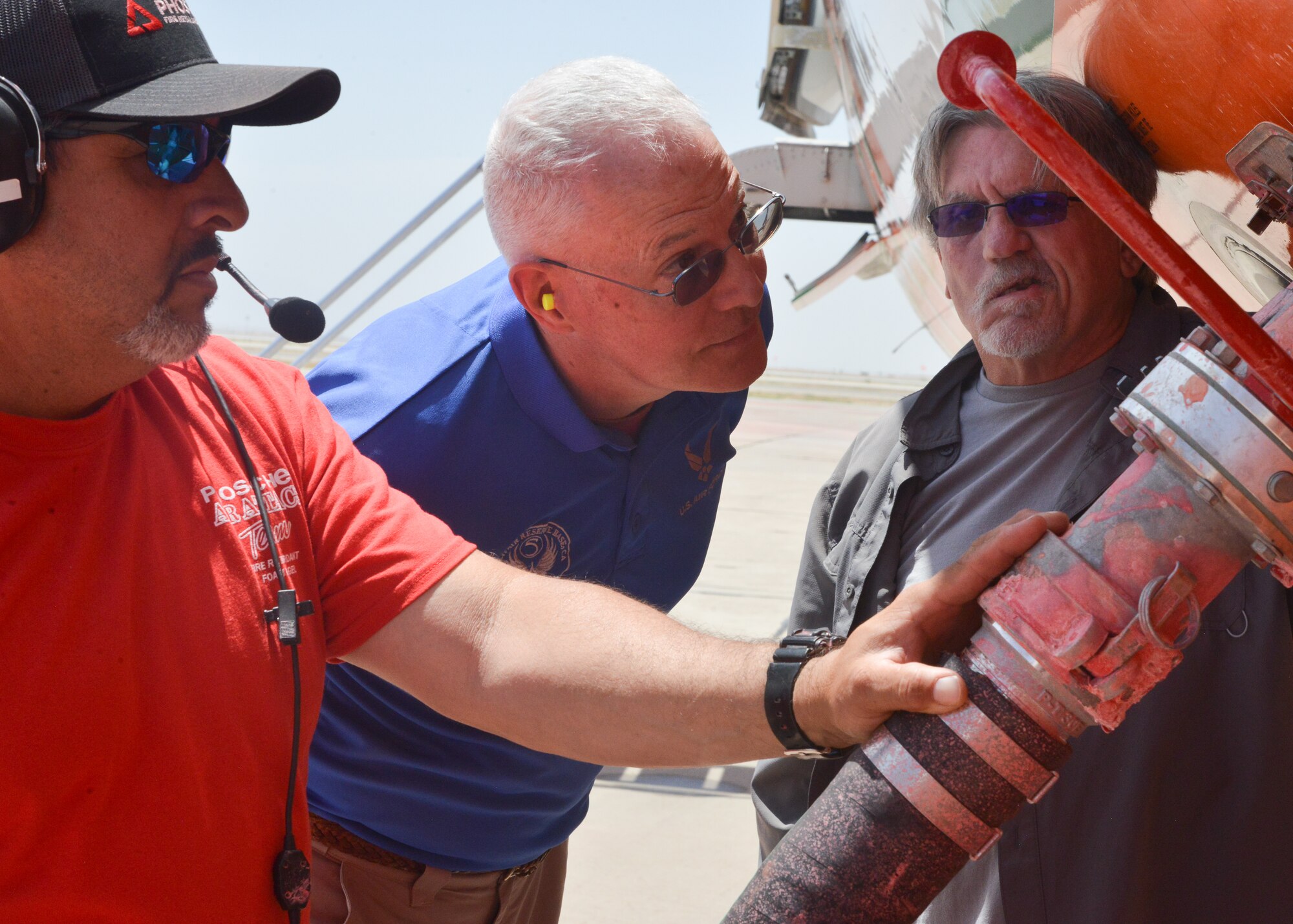 Men standing on flight line.
