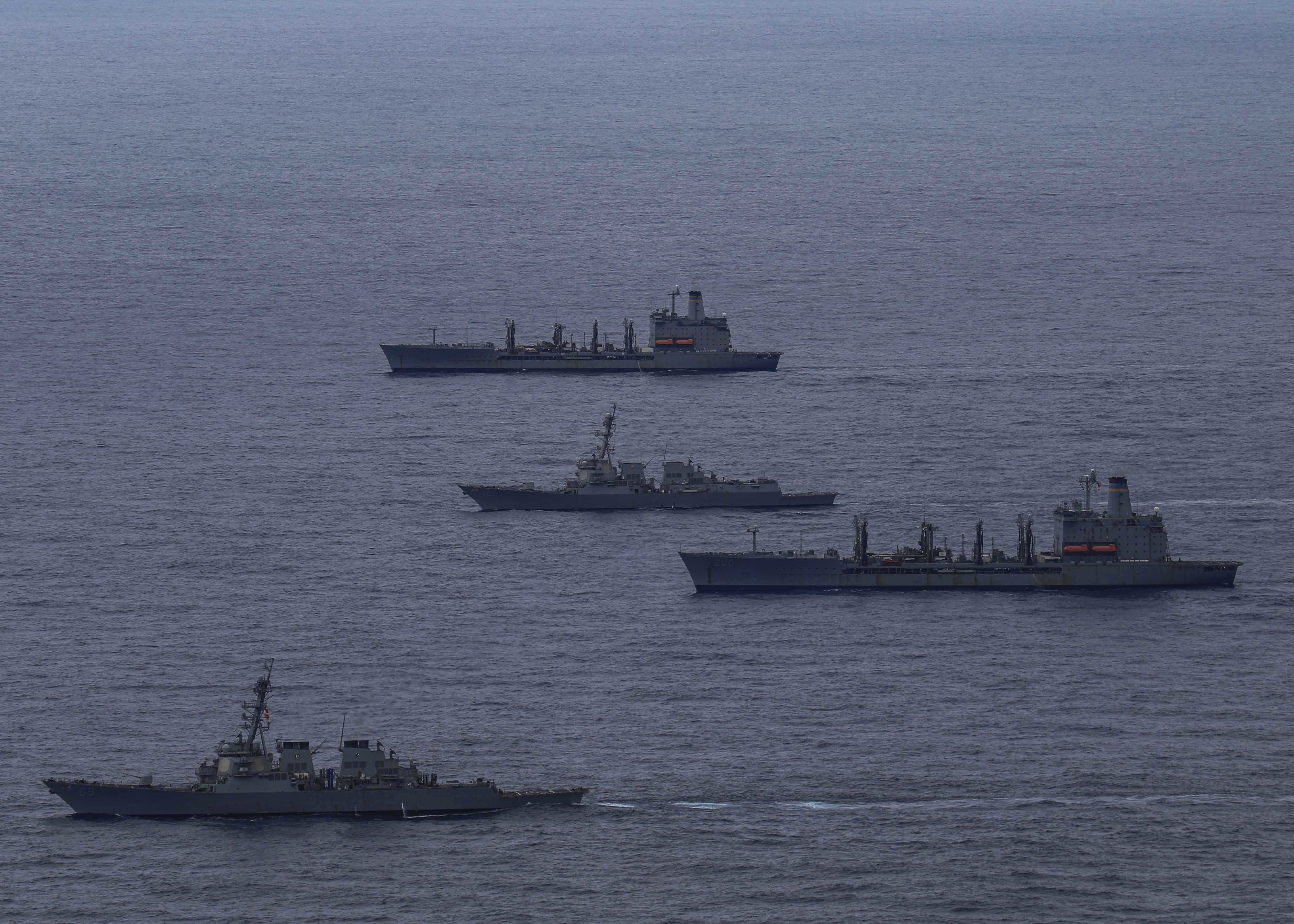 The Arleigh Burke-class guided-missile destroyers USS Milius (DDG 69) and USS Gridley (DDG 101) sail together with Henry J. Kaiser-class underway replenishment oilers USNS Guadalupe (T-AO 200) and USNS Rappahannock (T-AO 204) in the Pacific Ocean.