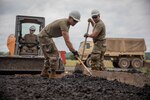 Air National Guard Airman First Class Cabrera, 124th Civilian Engineer Squadron, smooths out gravel as a part of an Innovative Readiness Training mission while building homes for the Cherokee Veterans Housing Initiative in Tahlequah, Oklahoma, June 6, 2022. IRT is a Department of Defense initiative that is a joint environment with National Guard Soldiers and Airmen.