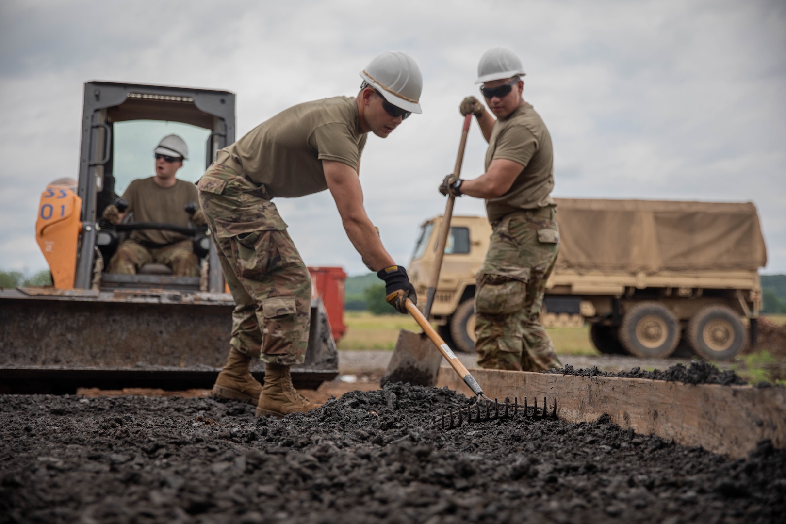 Air National Guard Airman First Class Cabrera, 124th Civilian Engineer Squadron, smooths out gravel as a part of an Innovative Readiness Training mission while building homes for the Cherokee Veterans Housing Initiative in Tahlequah, Oklahoma, June 6, 2022. IRT is a Department of Defense initiative that is a joint environment with National Guard Soldiers and Airmen.