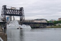 The Zumwalt-class destroyer USS Michael Monsoor (DDG 1001) passes beneath Steel Bridge in Portland, Oregon for Portland Fleet Week 2022.