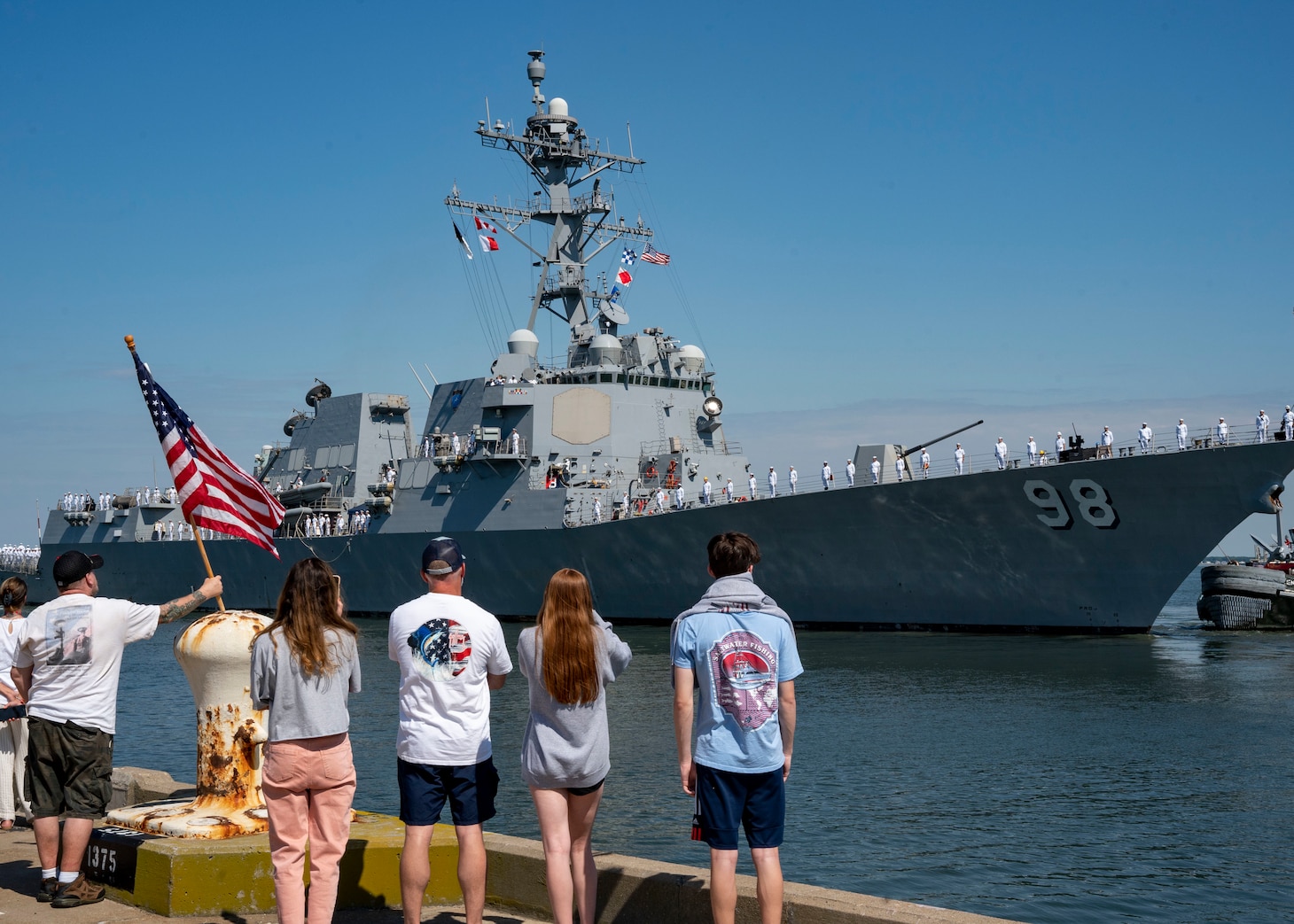 Family members of a Sailors assigned to the Arleigh Burke-class guided-missile destroyer USS Forrest Sherman (DDG 98) watche as the ship departed on deployment from its home port of Norfolk, June 11.