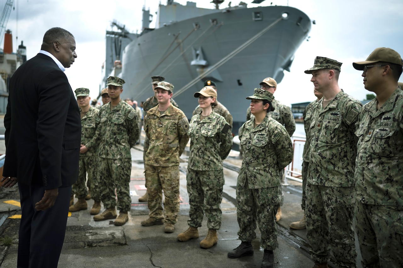 Secretary of Defense Lloyd J. Austin III speaks with service members.