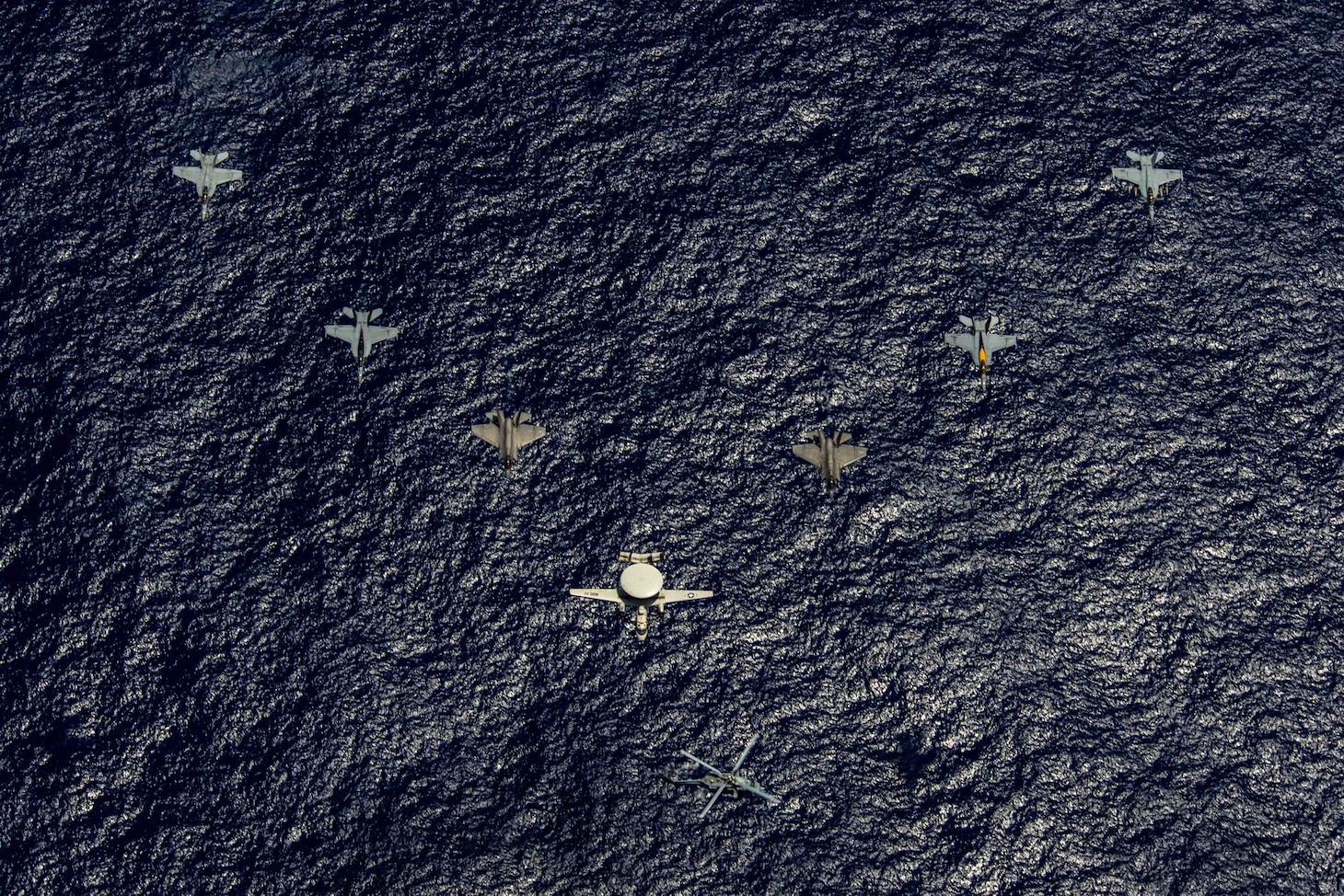 PHILIPPINE SEA (June 12, 2022) Aircraft from Carrier Air Wing (CVW) 9 fly in formation during Valiant Shield 2022 (VS22). VS22 is a U.S.-only, biennial field training exercise (FTX) focused on integration of joint training in a multi-domain environment. This training builds real-world proficiency in sustaining joint forces through detecting, locating tracking, and engaging units at sea, in the air, on land, and in cyberspace in response to a range of missile areas. (U.S. Navy photo by Mass Communication Specialist 3rd Class Michael Singley)