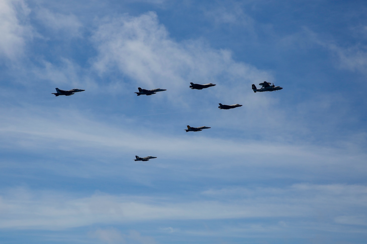 PHILIPPINE SEA (June 12, 2022) Aircraft from Carrier Air Wing (CVW) 9 fly in formation during Valiant Shield 2022 (VS22). VS22 is a U.S.-only, biennial field training exercise (FTX) focused on integration of joint training in a multi-domain environment. This training builds real-world proficiency in sustaining joint forces through detecting, locating tracking, and engaging units at sea, in the air, on land, and in cyberspace in response to a range of missile areas. (U.S. Navy photo by Mass Communication Specialist 3rd Class Michael Singley)