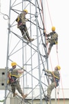 Officers from the Montenegrin army and members of the Maine Air National Guard climb a communications tower at the South Portland Air National Guard Station June 1, 2022. Four officers from Montenegro participated in communications familiarization events with the 243rd Engineering Installations Squadron and 265th Combat Communications Squadron during a State Partnership Program visit.