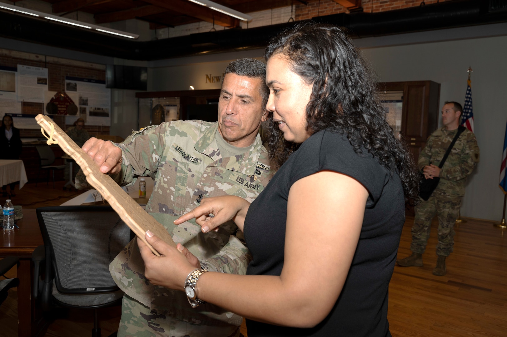 From left, Maj. Gen. David Mikolaities, New Hampshire adjutant general, presents Cabo Verde Minister of Defense Janine Lélis with an intricately carved map of the state at the end of a State Partnership Program workshop June 10, 2022, in Concord, New Hampshire. Lélis and delegates from the African archipelagic country visited June 8-10 to discuss NHNG capabilities and opportunities to work together.