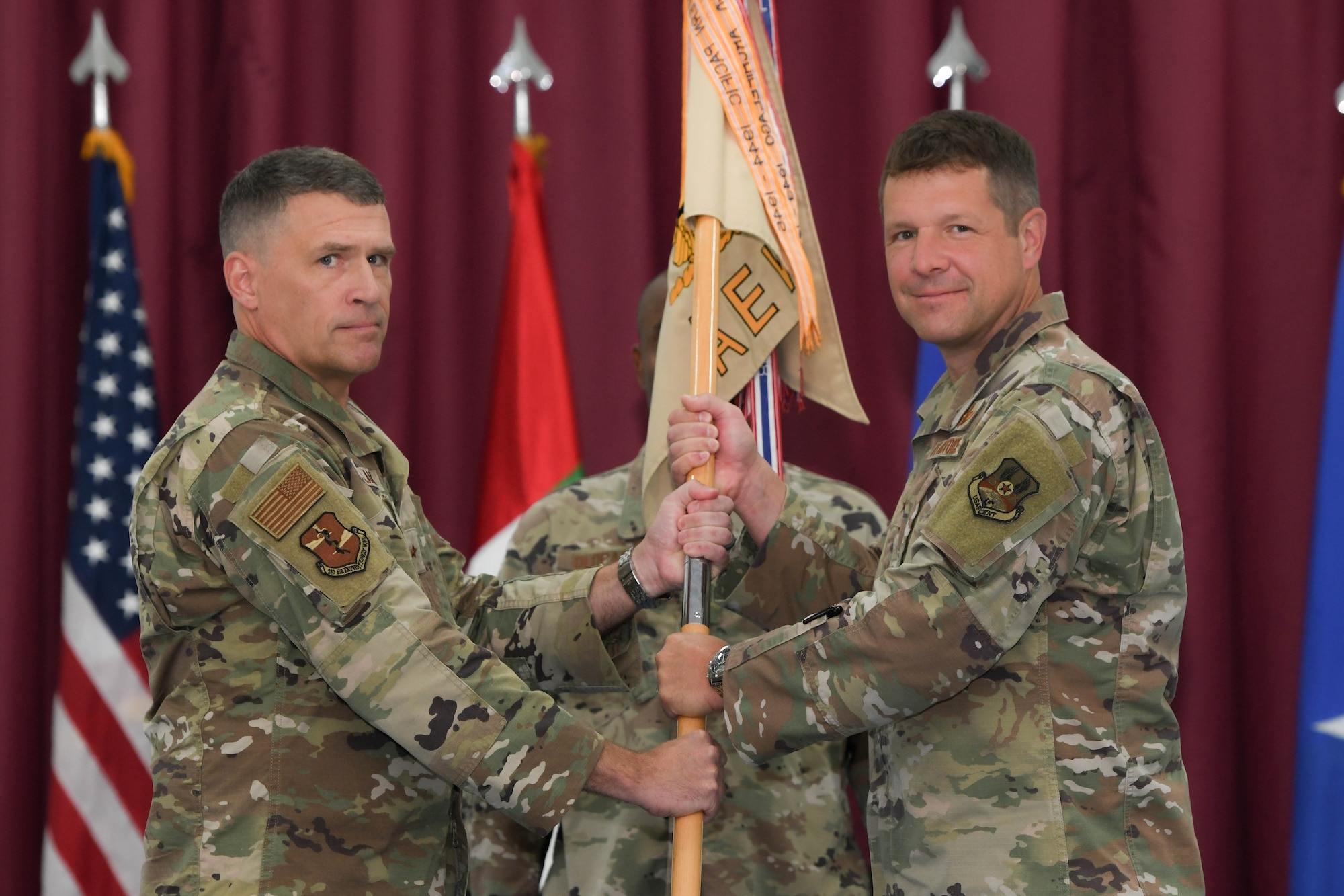 Brig. Gen. Andy “Spoo” Clark (left), the previous commander of the 380th Air Expeditionary Wing, relinquishes command to Brig. Gen. David “Shotgun” Lopez June 7, Al Dhafra Air Base, United Arab Emirates. Assuming this role, Lopez will be responsible for the Airmen and assets of 10 unique squadrons as well as the wing’s ground attack, intelligence, theatre security cooperation and in-transit airlift mission support.