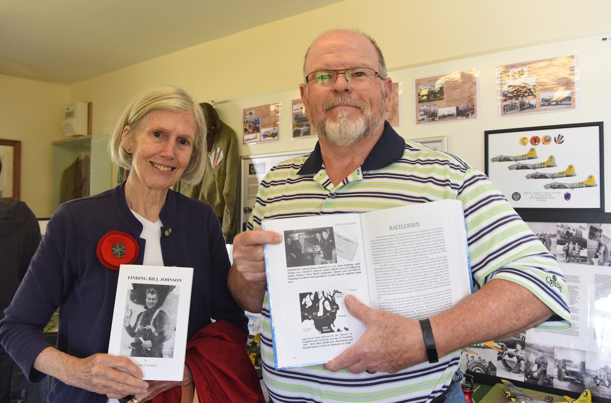 Priscilla Goldfarb, left, and Dana Flemming show photos of veterans from the 447th Bomb Group (Rattlesden) during a "Return to Rattlesden" event at the Suffolk airfield June 11, 2022. Flemming's father, 1st Lt. Dean Flemming, was a B-17 Flying Fortress pilot in the 709th Bomb Squadron, 447th BG. After a visit to Kent, England, several years ago, Goldfarb discovered a US flag and plaque marking the site of a B-17 plane crash in April 1944; she conducted much research on the pilot  -- Lt. William "Bill" Johnson, 711th Bomb Squadron, 447th BG -- who died after intentionally crashing his battle-damaged plane to avoid killing people in the nearby village. (Courtesy photo by Karen Abeyasekere)