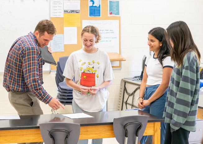 IMAGE: Naval Surface Warfare Center Dahlgren Division’s Dr. Spencer Beloin (left) sets up students for a game of Bayesian tennis in which they had to determine the location of where Beloin has placed the “ball” on the court. The game was part of Beloin’s STEM demonstration during the Fredericksburg Regional Summer Governor’s School at James Monroe High School, June 9.