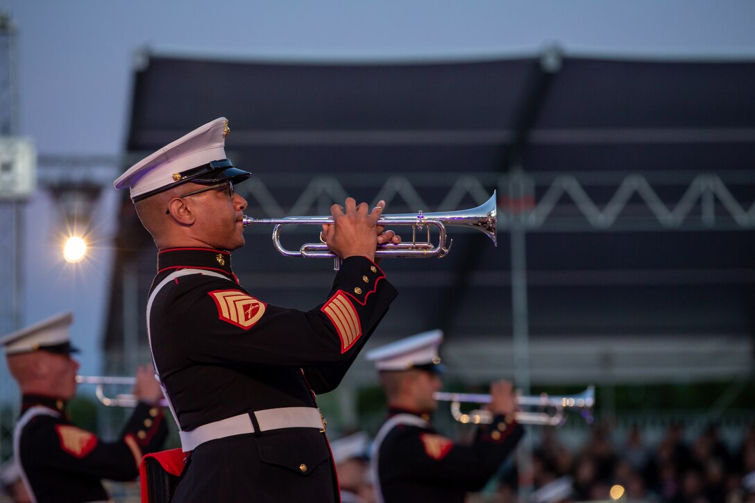 Members of a Marine Corps band play trumpets.
