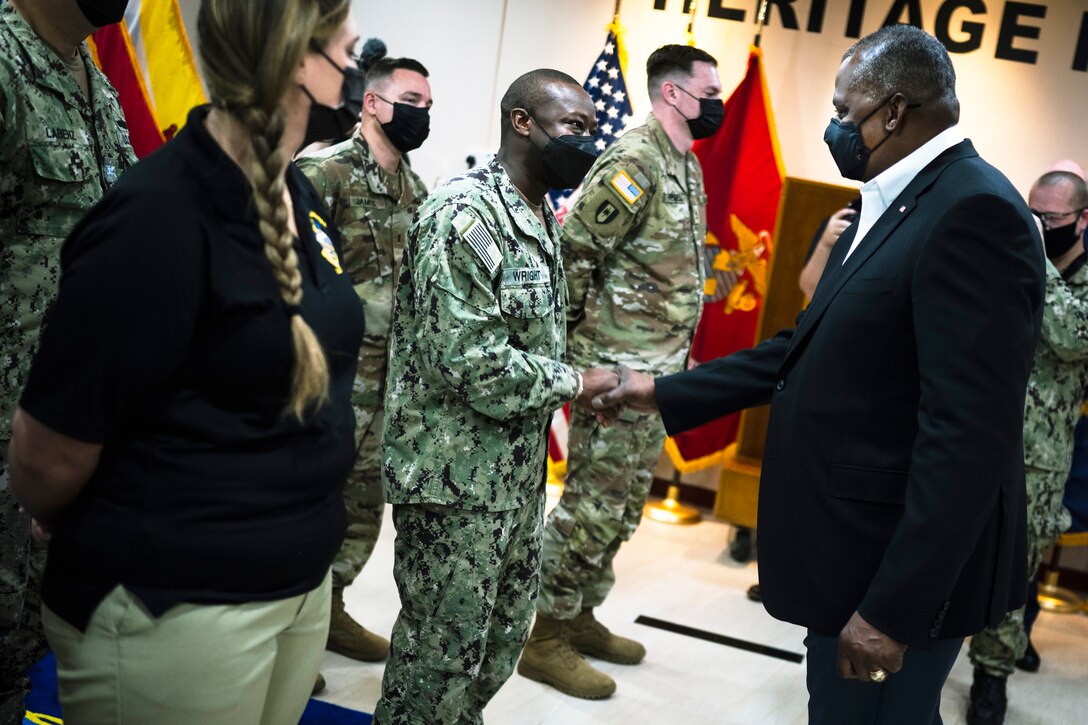 Secretary of Defense Lloyd J. Austin III speaks with service members.