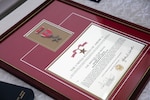 The framed certificate for Kentucky National Guard Sgt. John Burlew, awarded the Bronze Star Medal with Valor June 10, 2022, for his actions while deployed to Afghanistan in 2002.