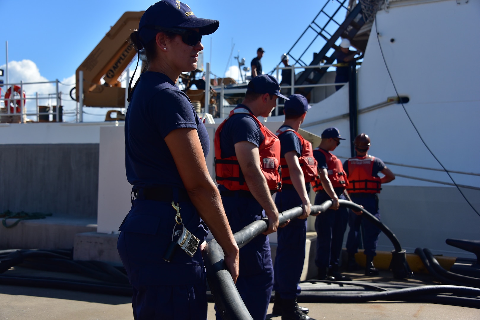Petty Officer 2nd Class Courtney Block, a gunner’s mate, helps take in lines connecting Coast Guard Cutter Kimball (WMSL 756) to shore power as the ship gets ready to depart for final sea trials Aug. 11, 2019.