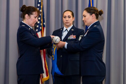 Lt. Col. Kristen Carter, right, outgoing 436th Medical Support Squadron commander, and Col. Tracy Allen, left, 436th Medical Group commander, furl the 436th MDSS guidon at The Landings on Dover Air Force Base, Delaware, June 9, 2022. Constituted in 1992, the 436th MDSS held an inactivation ceremony and was the first of four ceremonies conducted within the 436th MDG. Guidon bearer for the ceremony was Master Sgt. Amy Schwiesow, center, 436th MDSS superintendent. (U.S. Air Force photo by Roland Balik)