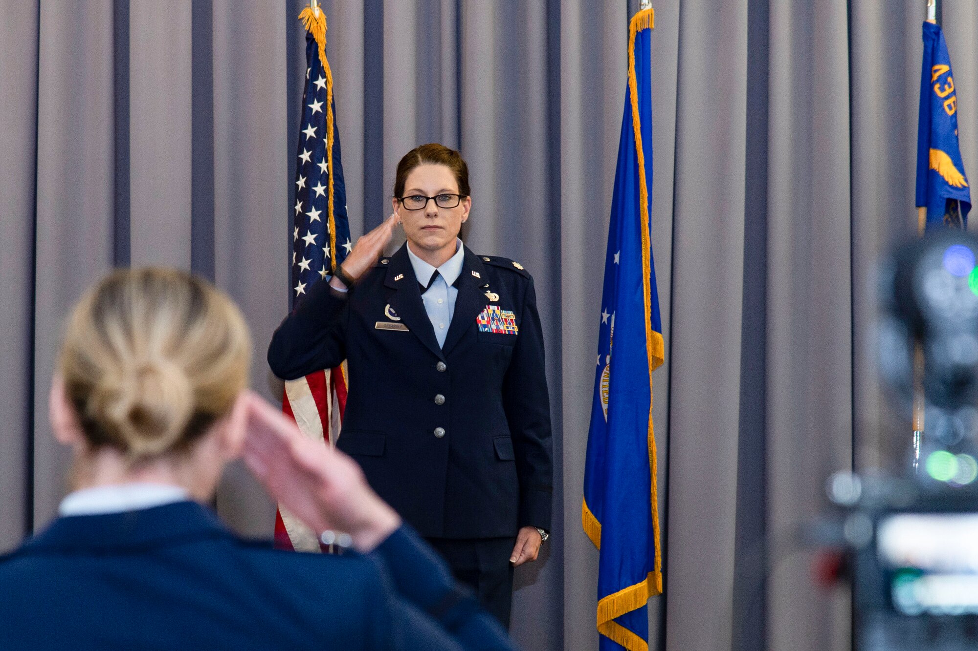 Lt. Col. Sara Spearing, center, 436th Health Care Operations Squadron commander, receives her first salute from Lt. Col. Kathleen Drum, left, 436th HCOS medical services flight commander, during a change of command ceremony held at The Landings on Dover Air Force Base, Delaware, June 9, 2022. The 436th HCOS Change of Command was the second of four ceremonies conducted within the 436th MDG. (U.S. Air Force photo by Roland Balik)