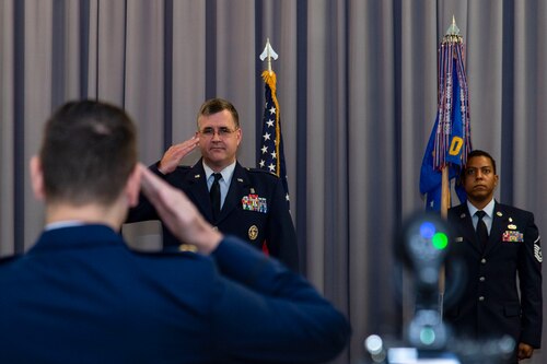Lt. Col. John Batka, center, 436th Operational Medical Readiness Squadron commander, receives his first salute from Maj. Mark Noakes, 436th OMRS mental health flight commander, during a change of command ceremony held at The Landings on Dover Air Force Base, Delaware, June 9, 2022. The 436th OMRS Change of Command was the third of four ceremonies conducted within the 436th MDG. Guidon bearer for the ceremony was Master Sgt. Andrew Burgos, right, 436th OMRS superintendent. (U.S. Air Force photo by Roland Balik)