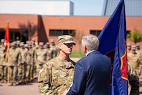 Brig. Gen. Levon E. Cumpton, incoming adjutant general of the Missouri National Guard, receives the state colors from Missouri Governor Mike Parson during a change of command ceremony at the Ike Skelton Training Site in Jefferson City, Missouri, Sept. 7, 2019. The ceremony marked the change of the Missouri National Guard commander from outgoing Maj. Gen. Stephen Danner to incoming Brig. Gen. Levon E. Cumpton. Danner will retire after nearly four decades of service to the state and nation. (U.S. Air National Guard photo by Tech. Sgt. Patrick Evenson)