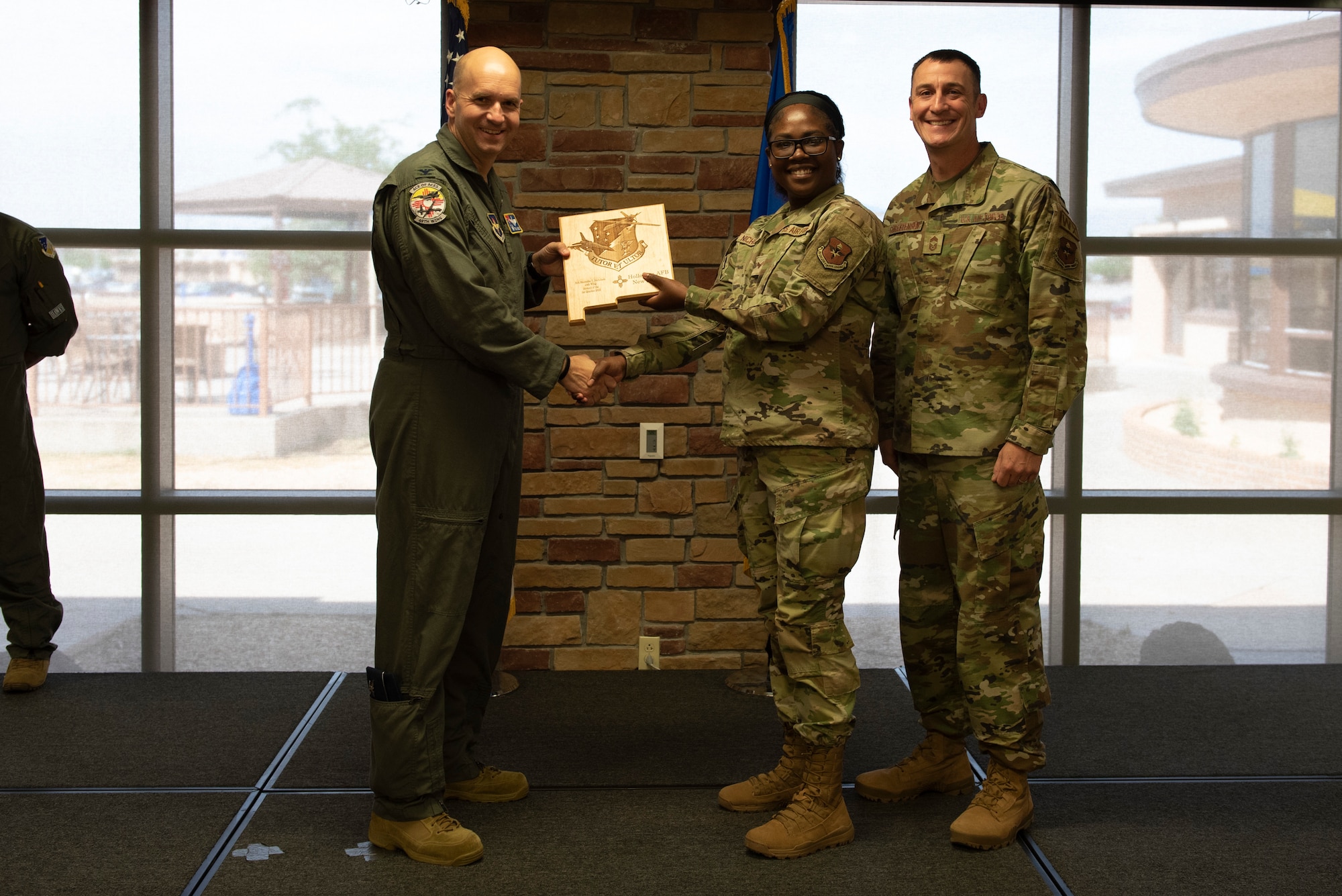 Senior Airman Shamelia Nicholson, from the 49th Security Forces Squadron, accepts the Airman of the Quarter Award during the 49th Wing’s 1st quarter awards ceremony, June 10, 2022, on Holloman Air Force Base, New Mexico.