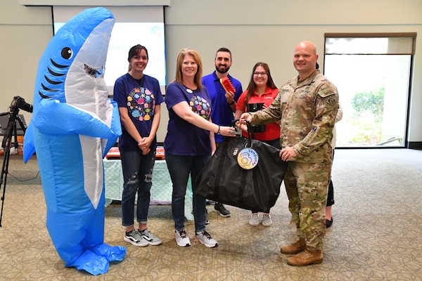 MAJ Gary Cutler, Mobile District Deputy Commander, hands out a SandSnap bag to the Thomas B. Norton Librarian during the SandSnap event at the library in Gulf Shores, Alabama, on June 10, 2022. SandSnap is a project being conducted by ERDC to gather information on the different size of sand at beaches around the U.S. (U.S. Army photo by Chuck Walker)