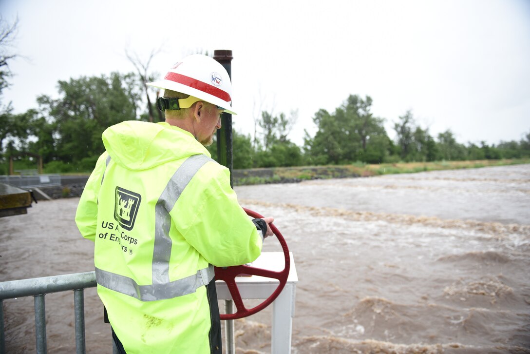 Austin Kuhlman, Operations Project Manager at Mill Creek, opens valve to divert water into Yellowhawk Creek.