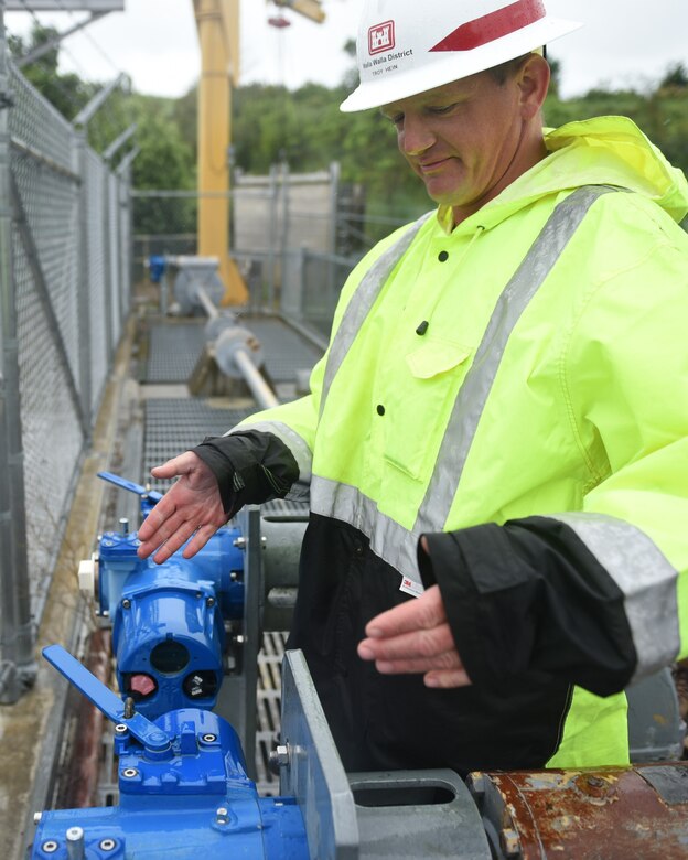 Troy Hein, Maintenance worker at Mill Creek, opens diversion dam gate to divert water into Bennington Lake.