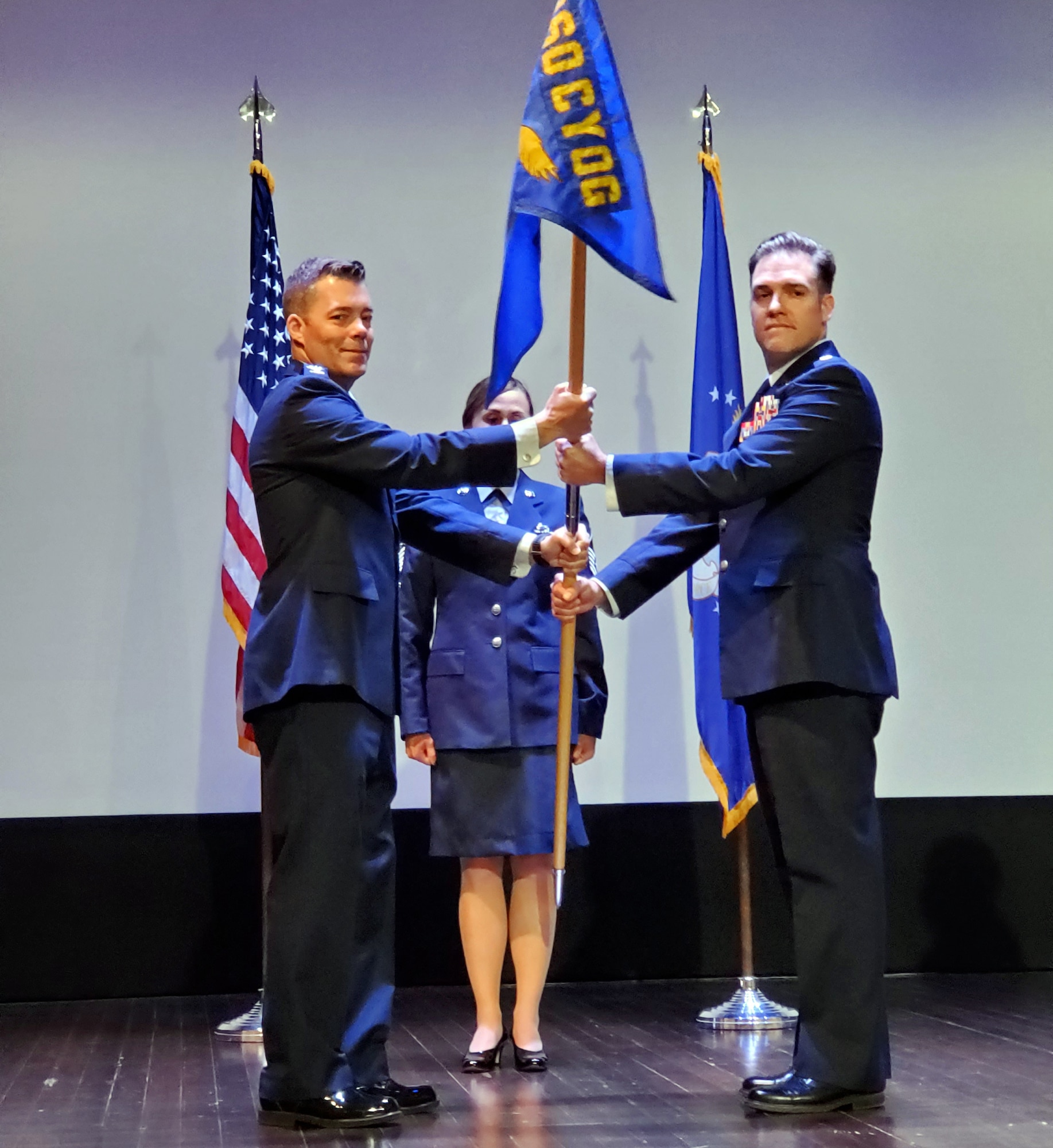 Col. Mark J. Estlund, 960th Cyberspace Operations Group commander, hands the 42nd Cyberspace Operations Squadron guidon to Lt. Col. Jeremiah J. Flerchinger signifying assumption of command June 5, 2022, at Scott Air Force Base, Illinois.