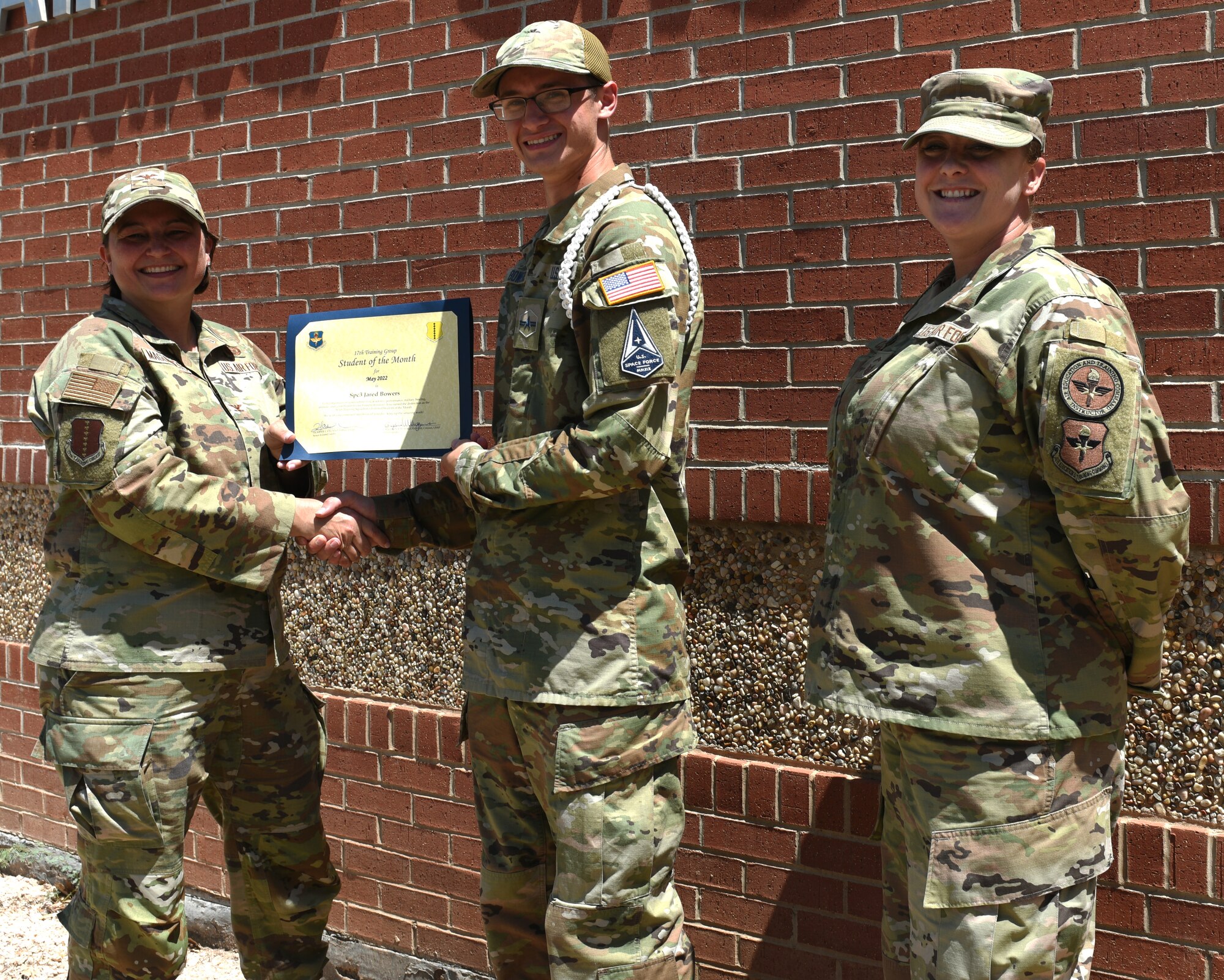 U.S. Air Force Col. Angelina Maguinness, 17th Training Group commander, and Senior Master Sgt. Heather Celano, 313th Training Squadron senior enlisted leader, presents the 315th Training Squadron Enlisted Student of the Month award to U.S. Space Force Specialist 3 Jared Bowers, 315th TRS student, Goodfellow Air Force Base, Texas, June 10, 2022. Bowers worked hard for his award and has shown his dedication to his squadron and the training he received at Goodfellow. (U.S. Air Force photo by Airman 1st Class Zachary Heimbuch)
