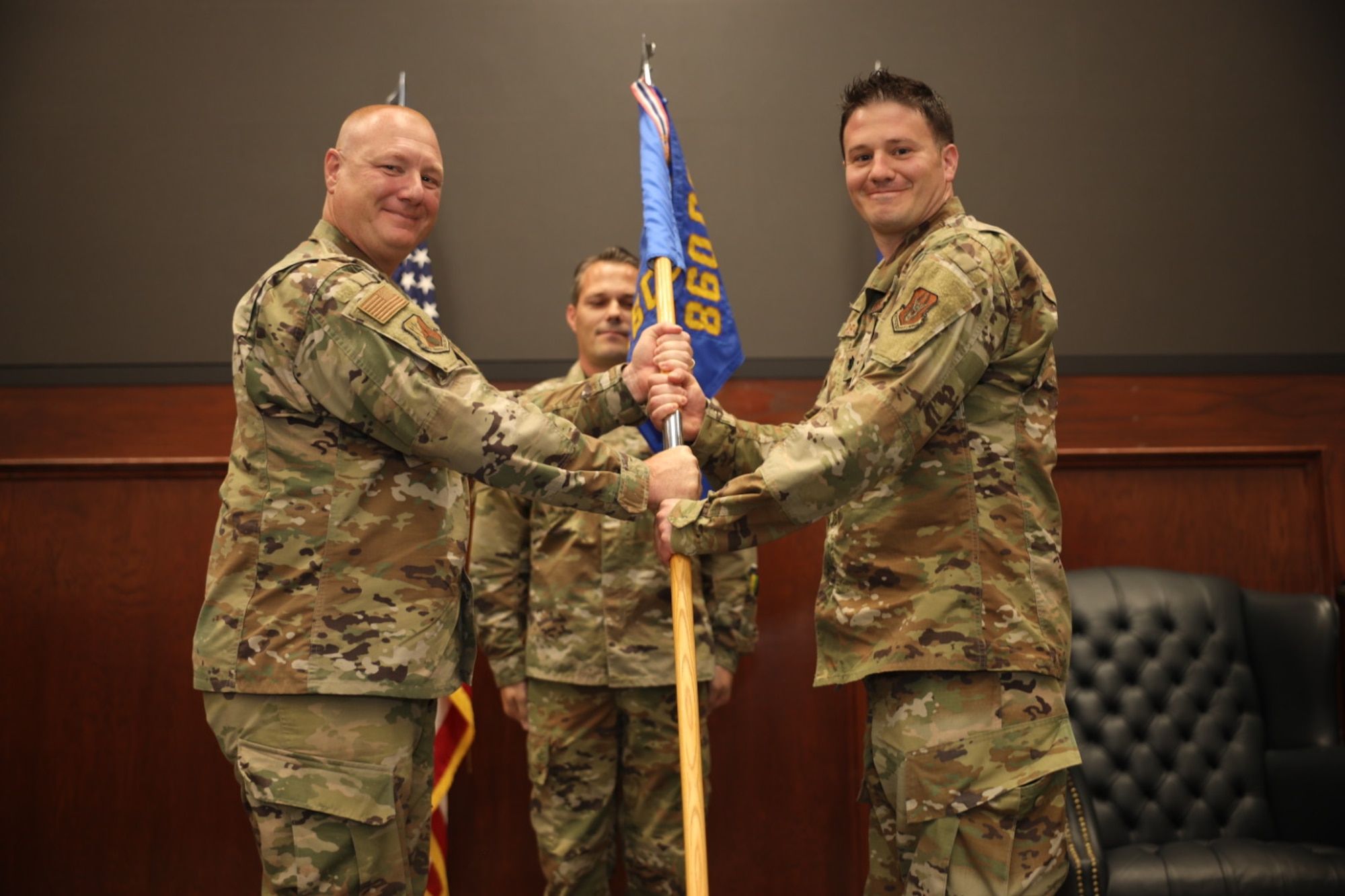 Col. Thaddeus Janicki, 860th Cyberspace Operations Group commander, passes the guidon to Lt. Col. Nathaniel Ferraco, signifying his assumption of command of the 35th Combat Communications Squadron June 4, 2022, at Tinker Air Force Base, Oklahoma.
