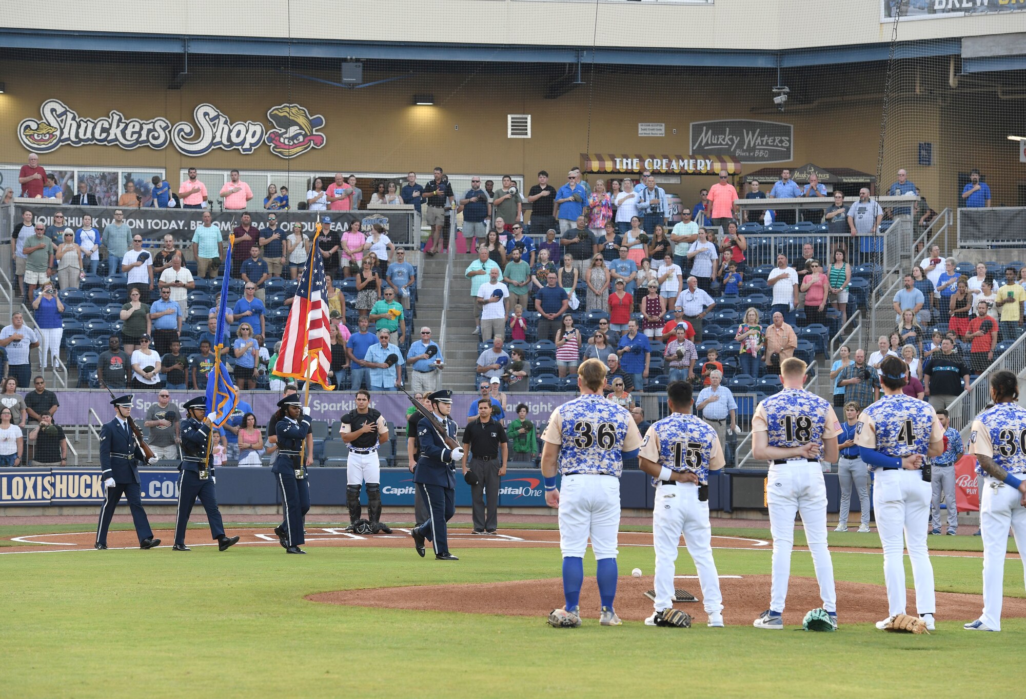 Members of the Keesler Air Force Base Honor Guard present the colors during the Biloxi Shuckers Minor League Baseball game in Biloxi, Mississippi, June 11, 2022. Members from Keesler Air Force Base participated in the pre-game festivities as the Shuckers hosted a military appreciation night where service members also received free tickets. (U.S. Air Force photo by Kemberly Groue)