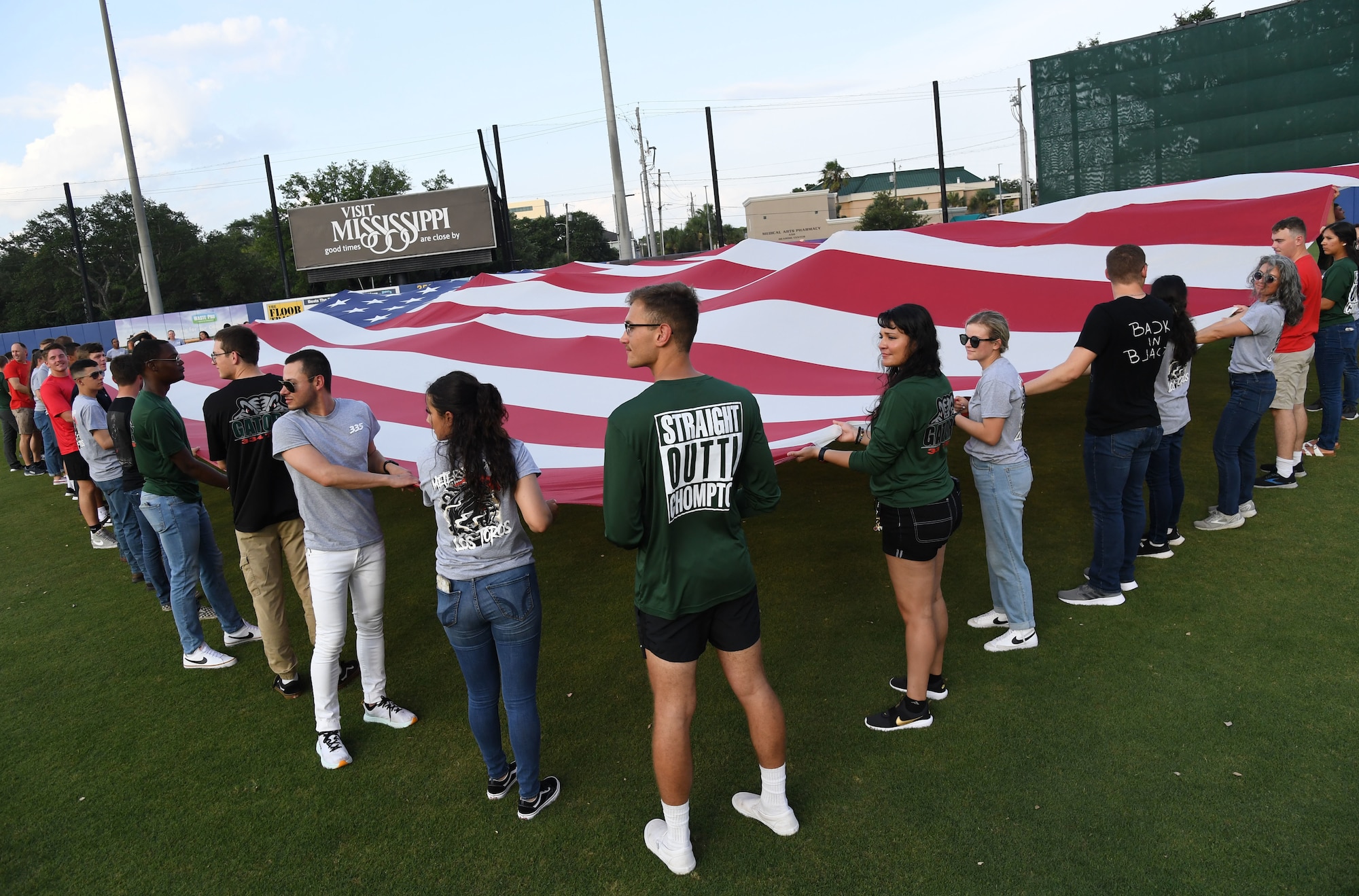 Airmen from the 81st Training Group hold a U.S. Flag during the Biloxi Shuckers Minor League Baseball game in Biloxi, Mississippi, June 11, 2022. The Shuckers hosted a military appreciation night where service members received free tickets. (U.S. Air Force photo by Kemberly Groue)