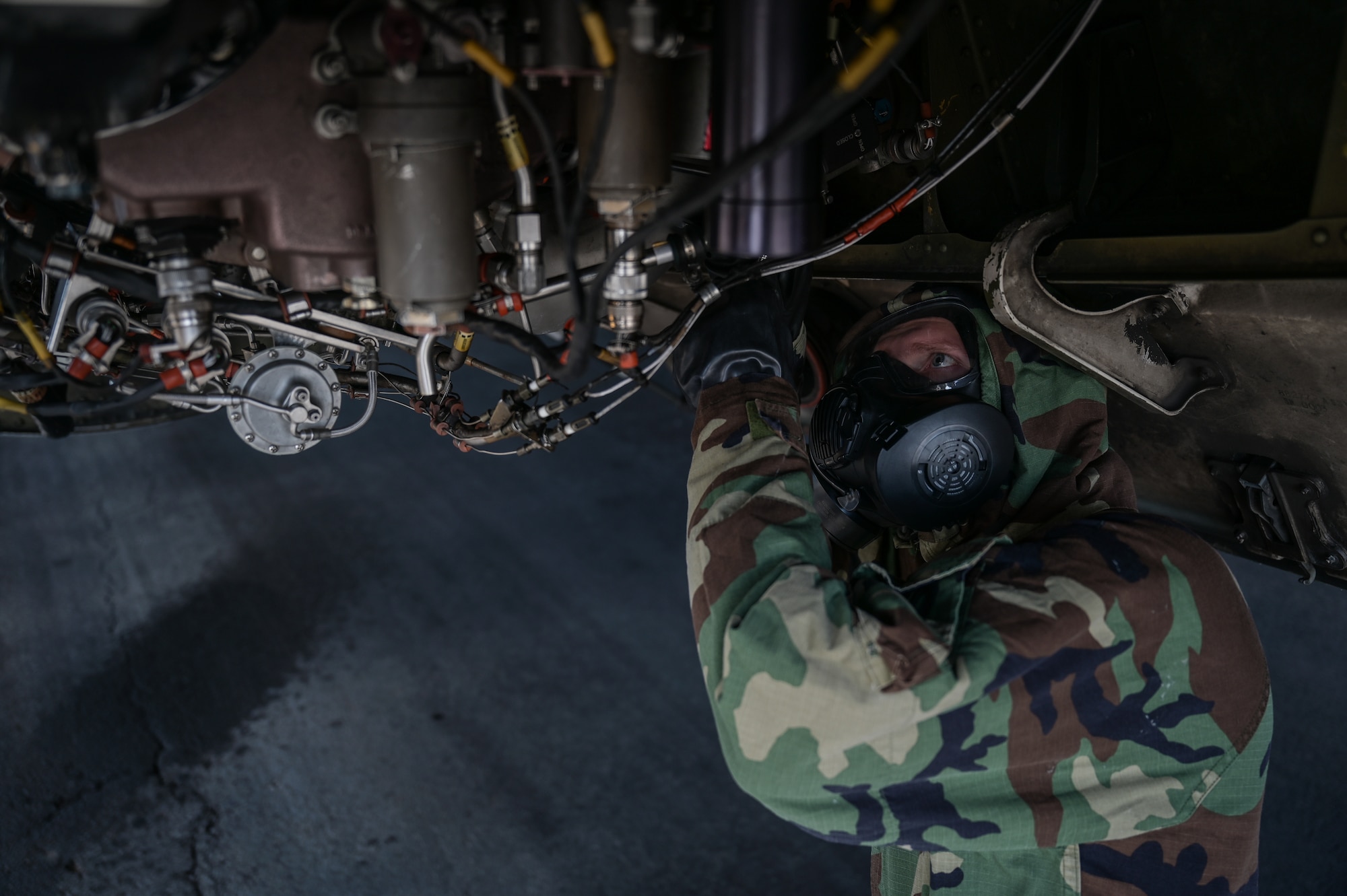 Senior Airman Tyler Hughes, 15th Aircraft Maintenance Squadron aerospace propulsion journeyman, inspects a C-17 Globemaster III auxiliary power unit in mission-oriented protective posture gear at Joint Base Pearl Harbor-Hickam, Hawaii, May 24, 2022. The 15th Maintenance implemented an Agile Combat Employment training plan on May 2, 2022, to increase the maintainer’s readiness and versatility. (U.S. Air Force photo by Staff Sgt. Alan Ricker)