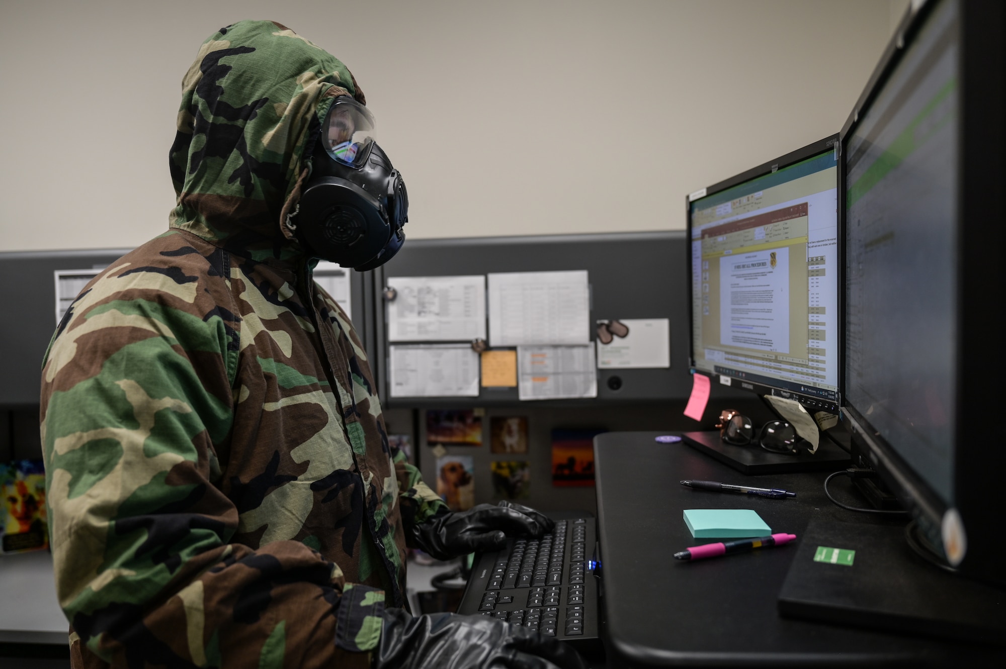 Tech. Sgt. Kevin Wu, 15th Maintenance Group maintenance qualification training program instructor, performs administration duties on a computer in mission-oriented protective posture gear at Joint Base Pearl Harbor-Hickam, Hawaii, May 24, 2022. The 15th Maintenance Group implemented a 3-month Agile Combat Employment and chemical, biological, radiological, nuclear and high-yield explosive task qualification training plans to increase its readiness. (U.S. Air Force photo by Staff Sgt. Alan Ricker)