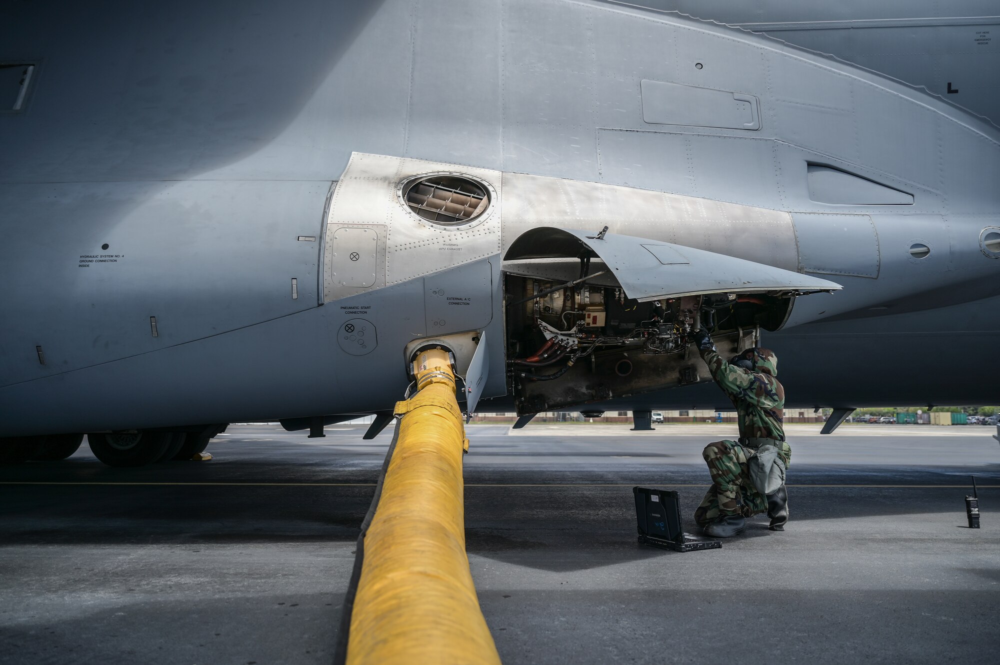 Senior Airman Tyler Hughes, 15th Aircraft Maintenance Squadron aerospace propulsion journeyman, inspects a C-17 Globemaster III auxiliary power unit in mission-oriented protective posture gear at Joint Base Pearl Harbor-Hickam, Hawaii, May 24, 2022. Fourteen 15th MXG personnel have been selected to participate in the 3-month ACE program to be trained on over 160 maintenance-specified tasks. (U.S. Air Force photo by Staff Sgt. Alan Ricker)