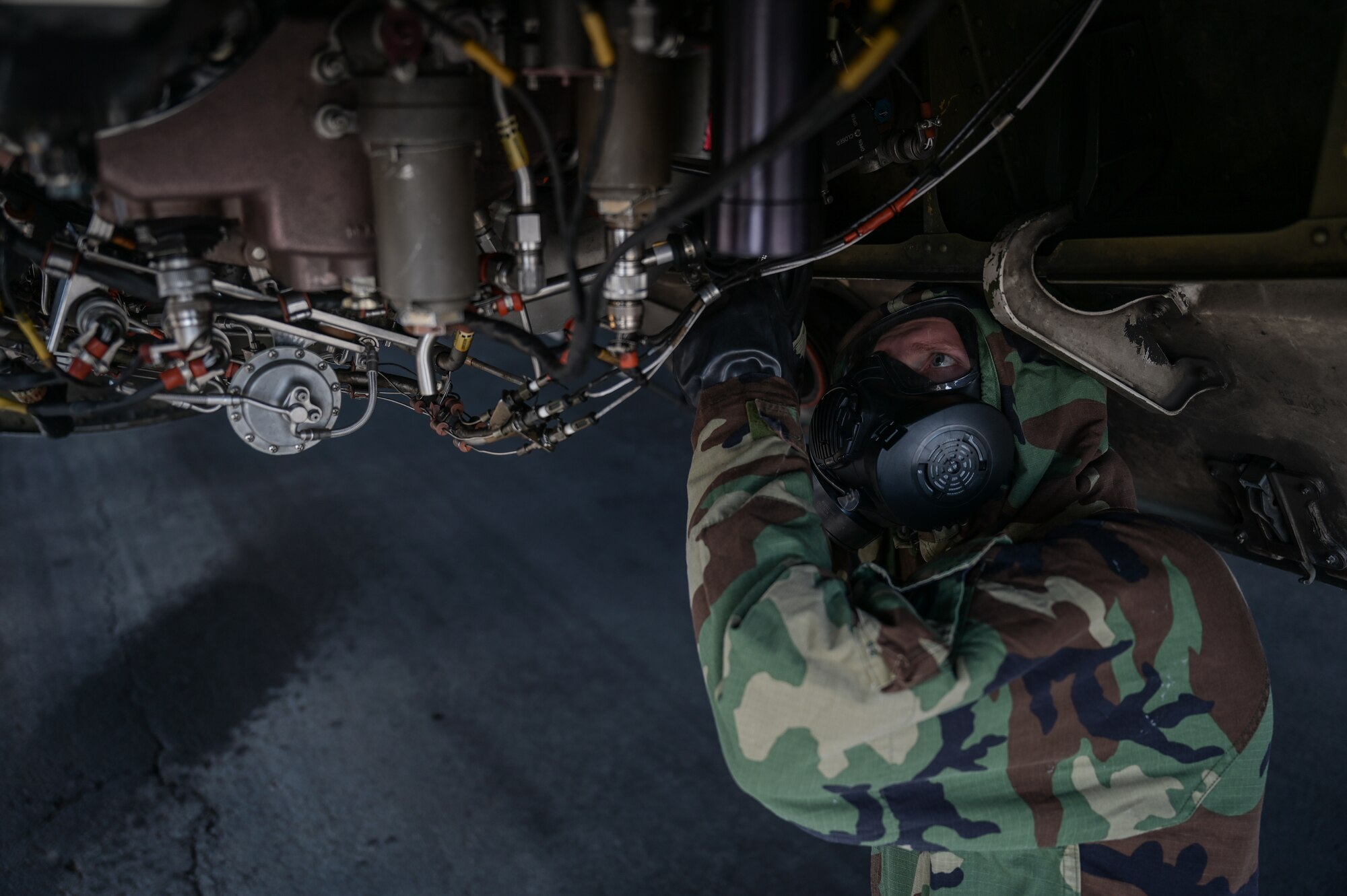 Senior Airman Tyler Hughes, 15th Aircraft Maintenance Squadron aerospace propulsion journeyman, inspects a C-17 Globemaster III auxiliary power unit in mission-oriented protective posture gear at Joint Base Pearl Harbor-Hickam, Hawaii, May 24, 2022. The 15th Maintenance implemented an Agile Combat Employment training plan on May 2, 2022, to increase the maintainer’s readiness and versatility. (U.S. Air Force photo by Staff Sgt. Alan Ricker)