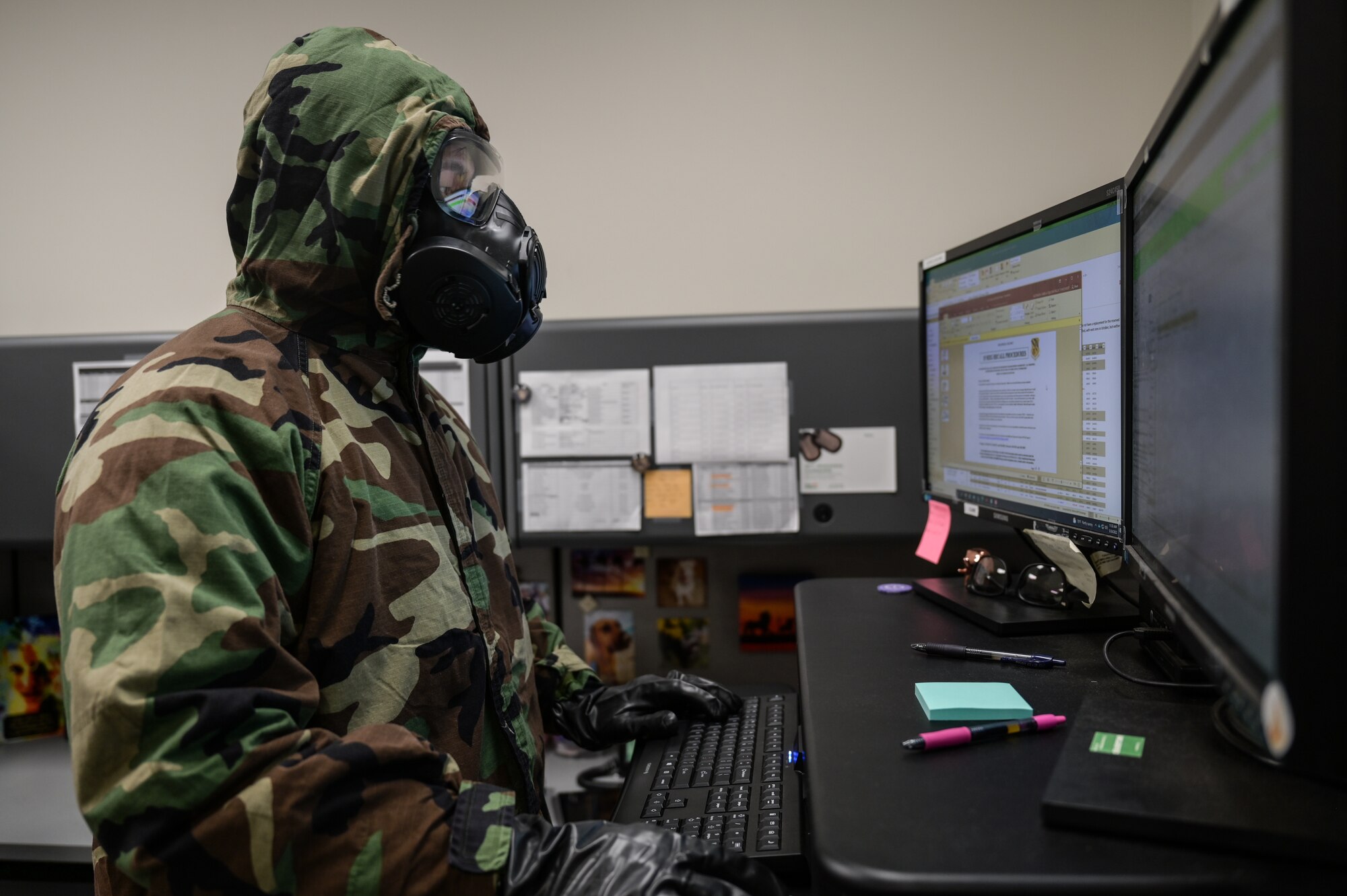 Tech. Sgt. Kevin Wu, 15th Maintenance Group maintenance qualification training program instructor, performs administration duties on a computer in mission-oriented protective posture gear at Joint Base Pearl Harbor-Hickam, Hawaii, May 24, 2022. The 15th Maintenance Group implemented a 3-month Agile Combat Employment and chemical, biological, radiological, nuclear and high-yield explosive task qualification training plans to increase its readiness. (U.S. Air Force photo by Staff Sgt. Alan Ricker)