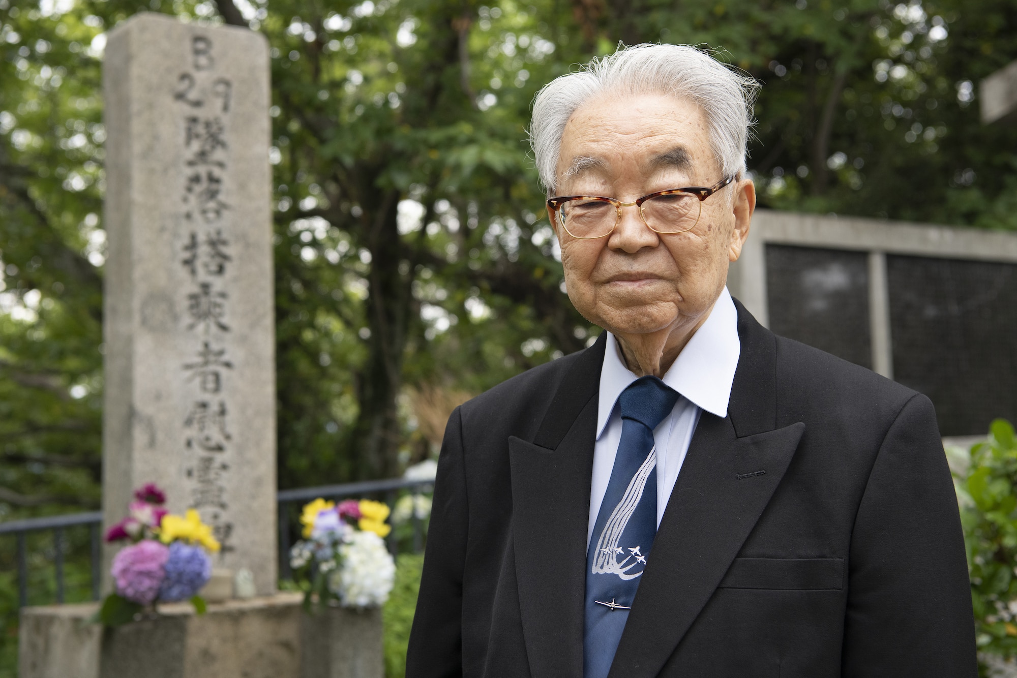 Dr. Hiroya Sugano, ceremony host, stands in front of a B-29 Monument during a U.S.-Japan Joint Memorial Service June 11, 2022, at Mt. Shizuhata in Shizuoka city, Japan. The memorial service provided participants the opportunity to honor those who lost their lives during a World War II air raid on June 20, 1945. During the raid, two U.S. Army Air Forces B-29 Superfortresses collided mid-air over Shizuoka City, resulting in the death of 23 Airmen on board the aircraft. Representatives of the U.S. Air Force’s Yokota Air Base, Japan Self Defense Force, and Shizuoka City rendered their respects to the Airmen and Japanese civilians who lost their lives as a result of the tragedy, and reflected on the strong alliance the U.S. and Japan have forged since the end of World War II. (U.S. Air Force photo by Tech. Sgt. Christopher Hubenthal)