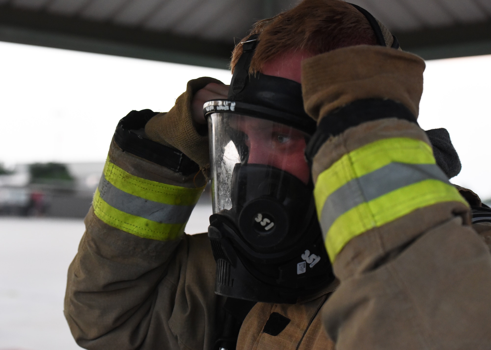 U.S. Army Pfc. Nathaniel Muszynski, 312th Training Squadron student, equips a self-contained breathing apparatus before a cylinder fire suppression training assessment, at Goodfellow Air Force Base, Texas, June 9, 2022. The SCBA allows the user to enter environments without the risk of inhaling hazardous fumes. (U.S. Air Force photo by Airman 1st Class Zachary Heimbuch)