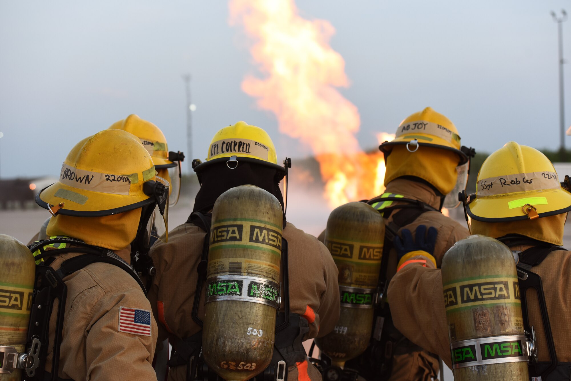 Students assigned to the 312th Training Squadron examine a gas cylinder fire for signs of a boiling liquid expansion vapor explosion during a training assessment, at Goodfellow Air Force Base, Texas, June 9, 2022. A BLEVE is telegraphed by the cylinder releasing a high pitched hiss and a pillar of fire, if the crew chief sees these signs, he evacuates his team from the area. (U.S. Air Force photo by Airman 1st Class Zachary Heimbuch)