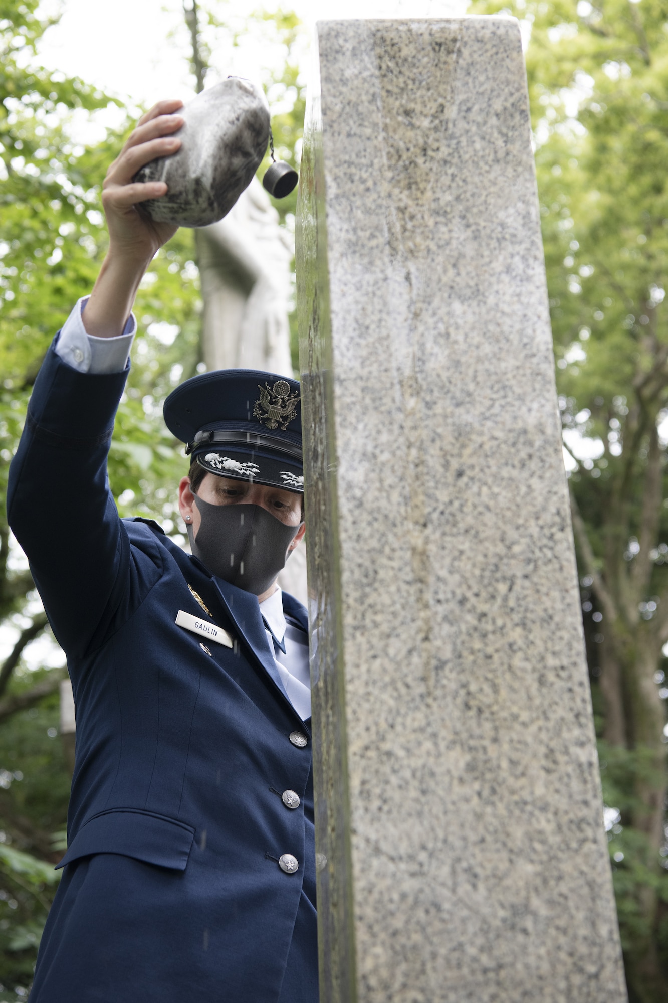 U.S. Air Force Col. Julie Gaulin, 374th Airlift Wing vice commander, pours bourbon over a B-29 Monument as a tradition to honor the fallen during a U.S.-Japan Joint Memorial Service June 11, 2022, at Mt. Shizuhata in Shizuoka city, Japan. The memorial service provided participants the opportunity to honor those who lost their lives during a World War II air raid on June 20, 1945. During the raid, two U.S. Army Air Forces B-29 Superfortresses collided mid-air over Shizuoka City, resulting in the death of 23 Airmen on board the aircraft. Representatives of the U.S. Air Force’s Yokota Air Base, Japan Self Defense Force, and Shizuoka City rendered their respects to the Airmen and Japanese civilians who lost their lives as a result of the tragedy, and reflected on the strong alliance the U.S. and Japan have forged since the end of World War II. (U.S. Air Force photo by Tech. Sgt. Christopher Hubenthal)