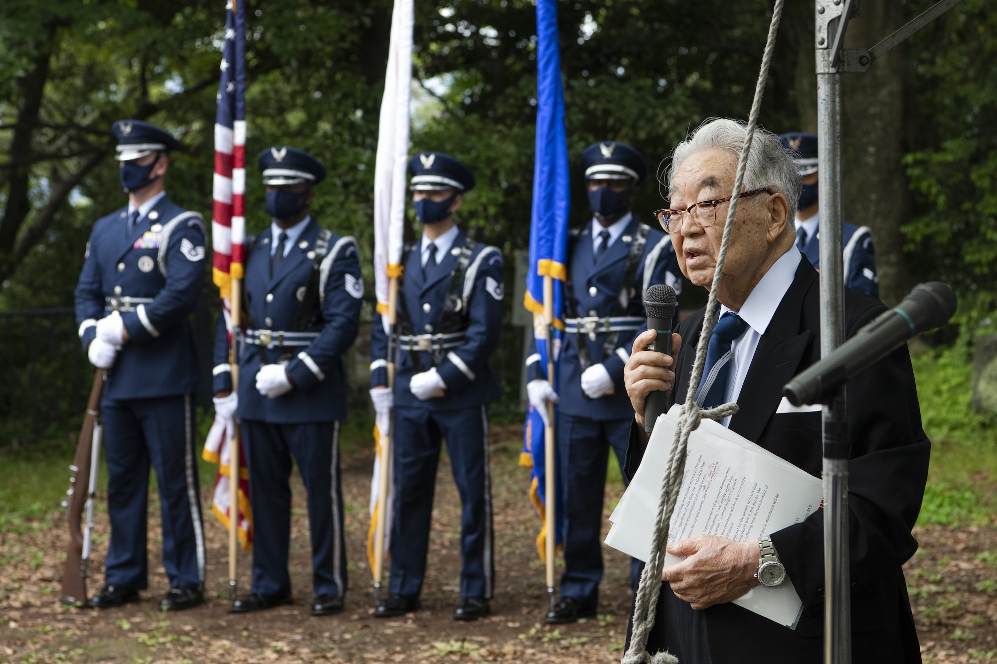 Dr. Hiroya Sugano, ceremony host, delivers a speech commemorating those who lost their lives during World War II as part of a U.S.-Japan Joint Memorial Service June 11, 2022, at Mt. Shizuhata, Shizuoka city, Japan. The memorial service provided participants the opportunity to honor those who lost their lives during a World War II air raid on June 20, 1945. During the raid, two U.S. Army Air Forces B-29 Superfortresses collided mid-air over Shizuoka City, resulting in the death of 23 Airmen on board the aircraft. Representatives of the U.S. Air Force’s Yokota Air Base, Japan Self Defense Force, and Shizuoka City rendered their respects to the Airmen and Japanese civilians who lost their lives as a result of the tragedy, and reflected on the strong alliance the U.S. and Japan have forged since the end of World War II. (U.S. Air Force photo by Tech. Sgt. Christopher Hubenthal)