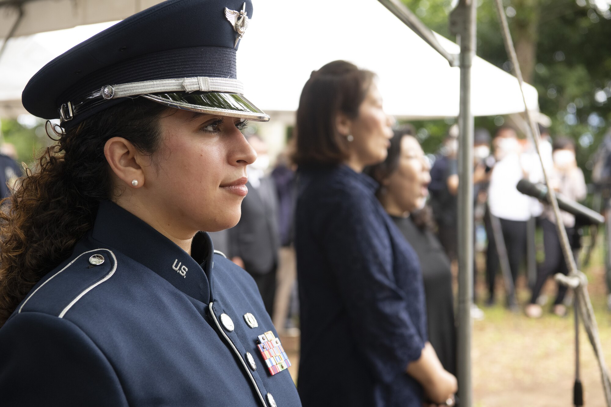 U.S. Air Force Senior Airman Alycia Cancel, U.S. Air Force Band of the Pacific regional bandsman vocalist, foreground, listens as Riho Tagawa and Chieko Nakatogawa, sing “Kimigayo,” the national anthem of Japan, during a U.S.-Japan Joint Memorial Service June 11, 2022, at Mt. Shizuhata, Shizuoka city, Japan. The memorial service provided participants the opportunity to honor those who lost their lives during a World War II air raid on June 20, 1945. During the raid, two U.S. Army Air Forces B-29 Superfortresses collided mid-air over Shizuoka City, resulting in the death of 23 Airmen on board the aircraft. Representatives of the U.S. Air Force’s Yokota Air Base, Japan Self Defense Force, and Shizuoka City rendered their respects to the Airmen and Japanese civilians who lost their lives as a result of the tragedy, and reflected on the strong alliance the U.S. and Japan have forged since the end of World War II. (U.S. Air Force photo by Tech. Sgt. Christopher Hubenthal)