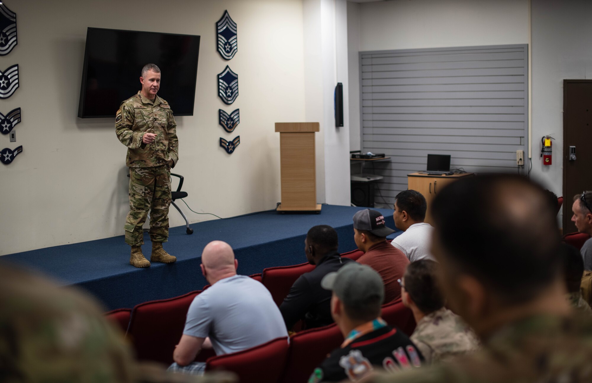 A military man talks to a crowd
