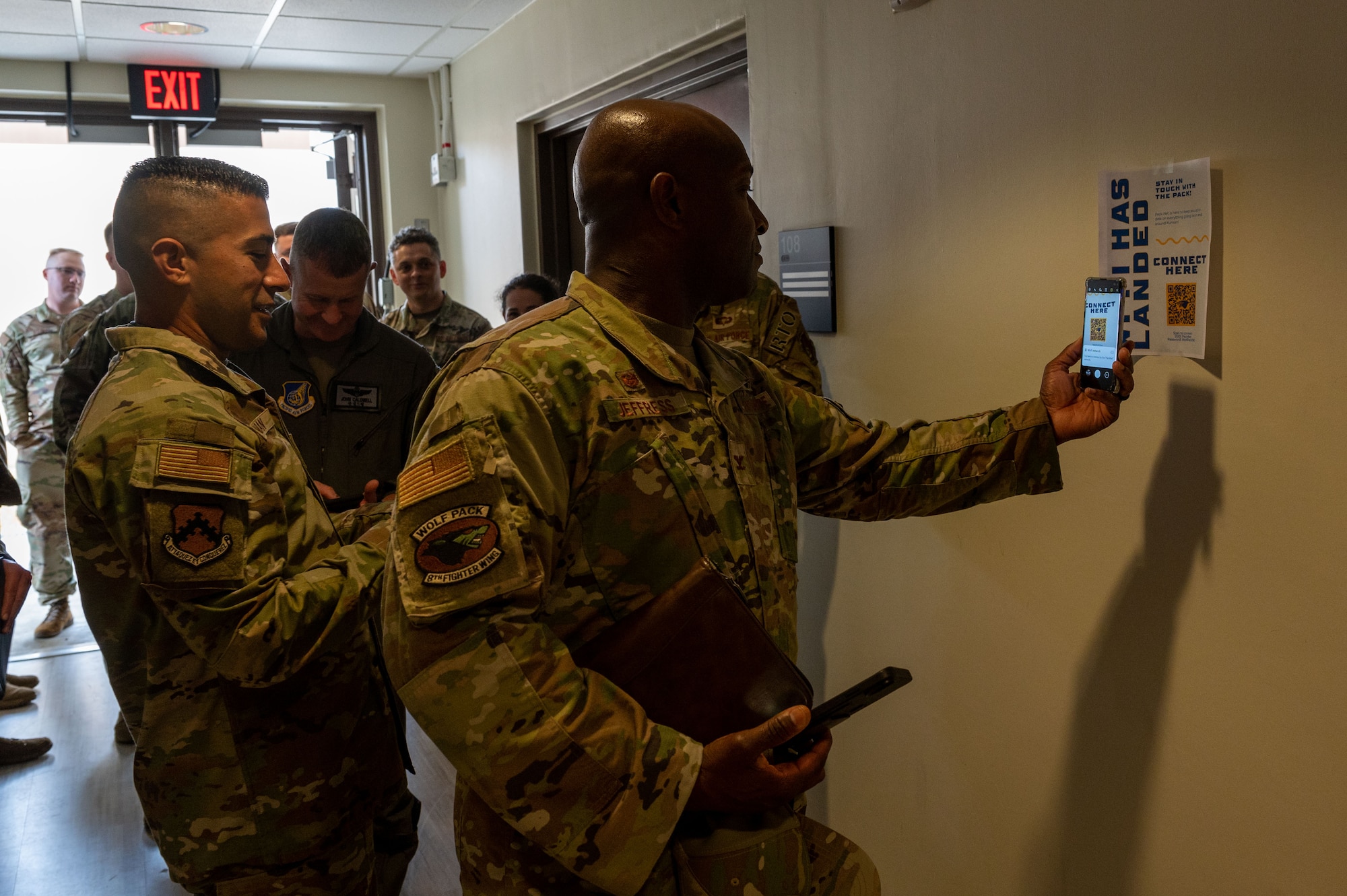 Col. Henry R. Jeffress, III, 8th Fighter Wing commander, scans a QR code to attach to the base Wi-Fi during an immersion brief at Kunsan Air Base, Republic of Korea, June 6, 2022. The goal of the project is to blanket the installation in free Wi-Fi so that Wolf Pack Airmen can stay connected at any point across the base. (U.S. Air Force Photo by Senior Airman Akeem K. Campbell)