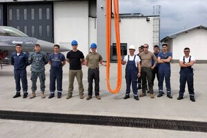U.S. Airmen from the 31st Maintenance Group and maintainers from the Romanian air force pose for a photo